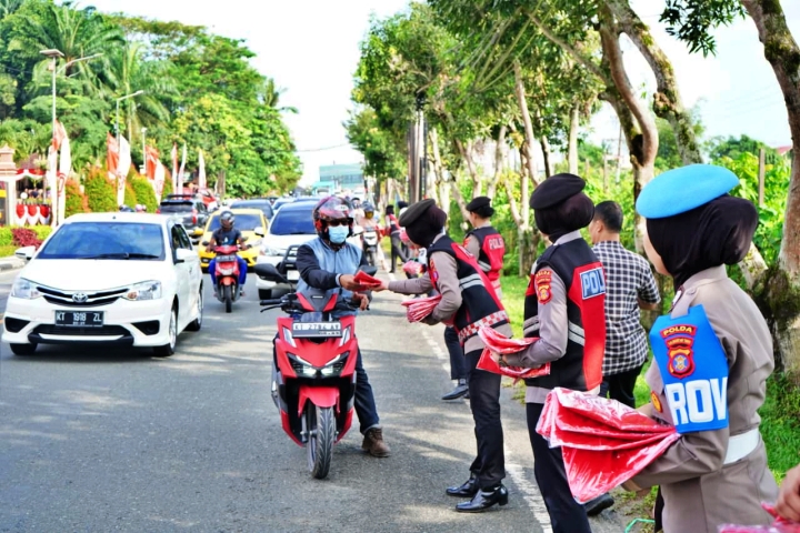 Giliran Polwan Polda Kaltim Bagikan Bendera Merah Putih